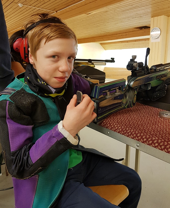 Otto sitting on a chair in the shooting hall looking into the camera